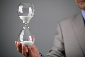 Man in suite holding an hourglass